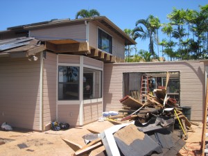 No more familyroom or back lanai roof. The old sliding glass door to the familyroom has been removed. The blue tape on the master bedroom wall shows the outline of the new peaked familyroom and lanai roofs.
