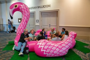 Image of Doug Nordman and seven other FinCon18 attendees sitting in a pink flamingo pool float at the Rosen Shingle Creek Resort in Orlando FL. | The-Military-Guide.com
