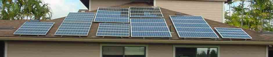 Picture of photovoltaic and solar water panels on top of a home's roof.