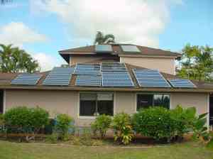 Picture of photovoltaic and solar water panels on top of a home's roof.