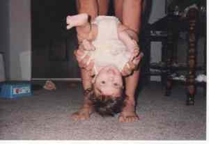 Why, yes, as a matter of fact our daughter *does* read this blog. She's seen this before. I think her spouse has too. He has now! Image of a smiling baby being held upside-down by her parent, showing that the parents suddenly placed more priority on their family than on their military careers. | The-Military-Guide.com