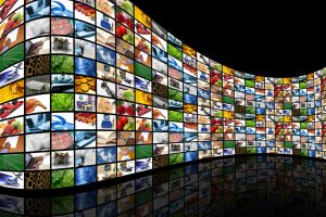 Image of a large curving wall of hundreds of TV screens against a black background. | The-Military-Guide.com