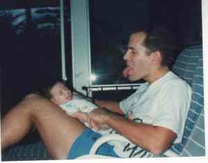 Photo of baby sticking out its tongue at parent.