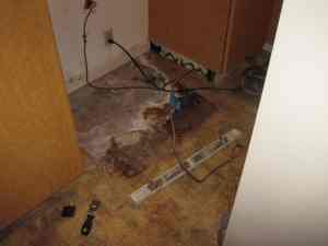 Image of dirt and debris under refrigerator from tenant not cleaning under it. | The-Military-Guide.com