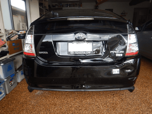 Image of black 2005 Prius vehicle damaged in a hit and run and repaired with cosmetic damage still present. | The-Military-Guide.com