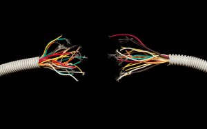 Image of two communications wires with frayed ends that have shredded apart. | MilitaryFinancialIndependence.com
