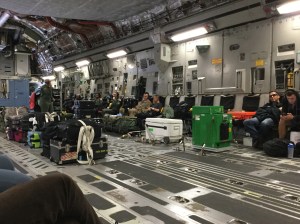 Image of the interior of an Air Force C-17 cargo jet with Space A passengers and lots of deck space for spreading out sleeping bags to take a nap | The-Military-Guide.com
