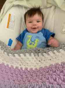 Either that or she's just happy to have a 529 account... Image of Doug Nordman's eight-week-old baby granddaughter Arya smiling in her bouncer chair. | The-Military-Guide.com