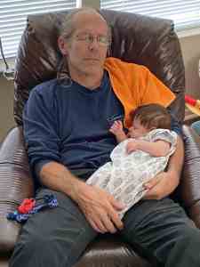 Hey, when the baby's sleeping, you should too. Image of Doug Nordman napping with his eight-week-old baby granddaughter Arya in his lap. | The-Military-Guide.com