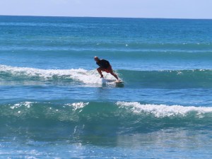 Image of Doug Nordman doing a Cheater Five on a longboard at White Plains Beach Oahu | MilitaryPersonalFinance.com