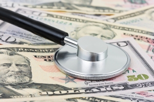 The good news is that it's not as bad as it looks...? Image of stethoscope on a pile of $50 bills | MilitaryFinancialIndependence.com
