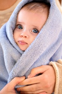 Image of baby wrapped in blue fuzzy warm security blanket | MilitaryFinancialIndependence.com